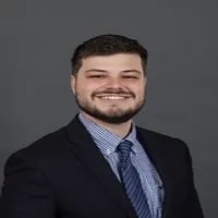 Grant Smith, Global Recruitment Marketing Specialist seen with a bright smile on his face